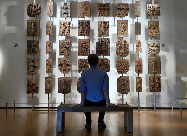 An employee poses as he views examples of Benin bronzes which, together with collections such as the Parthenon sculptures, are the subject of talks of their return to countries of origin, displayed at the British Museum in London, Britain, January 25, 2023. REUTERS/Toby Melville/File Photo
