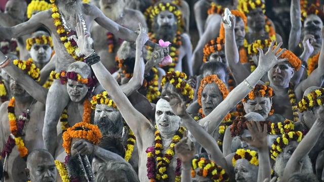 Naga Sadhus arrive in a procession to take a holy dip in Sangam, the confluence of Ganges, Yamuna and Saraswati rivers, at the Maha Kumbh Mela in Prayagraj.