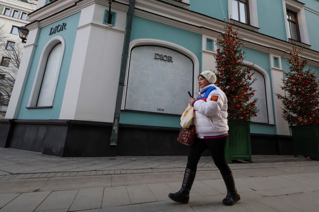 A woman walks past a closed Dior store in Moscow, Russia February 25, 2025.  REUTERS/Shamil Zhumatov