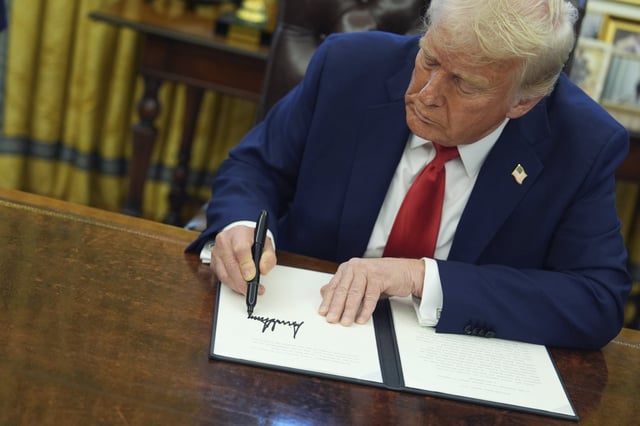 President Donald Trump signs an executive order in the Oval Office of the White House on Feb. 3, 2025.
