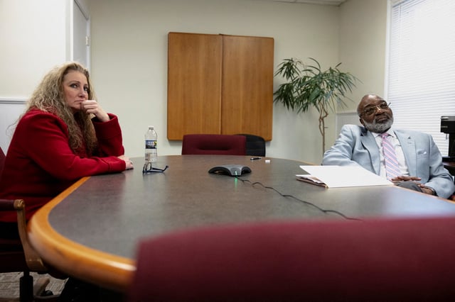 Marlean Ames sits with Edward Gilbert, her lawyer, during a meeting in his law office in Akron, Ohio, U.S., February 13, 2025. REUTERS/Megan Jelinger/File Photo