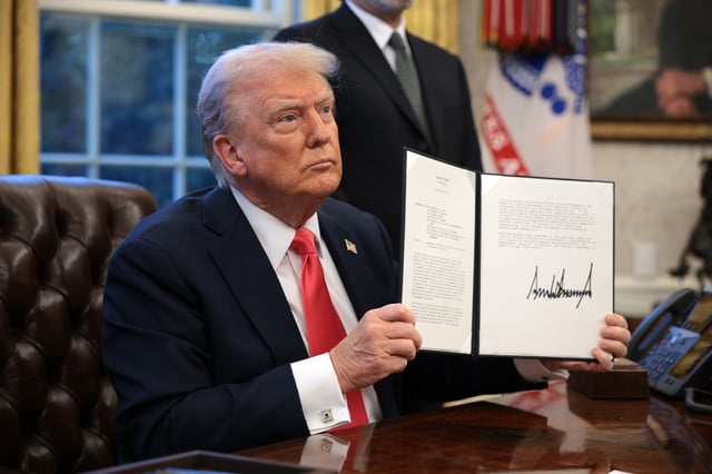 President Donald Trump signs an executive order in the Oval Office at the White House on February 25, 2025 in Washington, DC.
