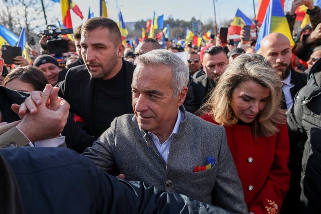 Romanian far-right presidential candidate Calin Georgescu greets his supporters as he arrives at a rally celebrating the Unification Day, in Bucharest, Romania, January 24, 2025. Inquam Photos/George Calin via REUTERS/File Photo