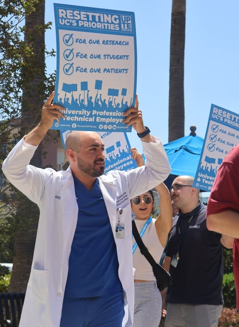 Over 20,000 healthcare, research and technical employees plan to strike at research labs and medical facilities across the 10-campus University of California system beginning Wednesday, Feb. 26, and continuing through Feb. 28. A member of the University Professional and Technical Employees-CWA Local 9119, protesting at the UC Irvine Health campus in Orange on Aug. 14, 2024, regarding staffing shortages and eroding patient care. (Photo courtesy of UPTE union)