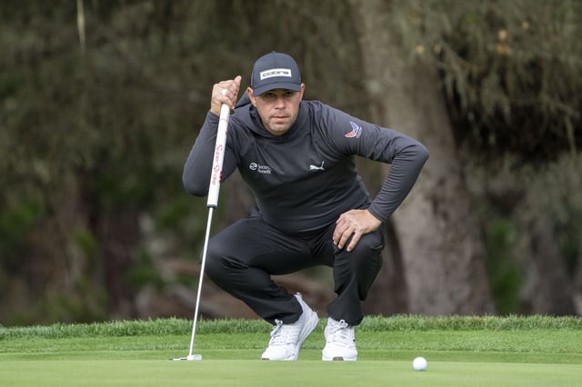 January 30, 2025; Pebble Beach, California, USA; Gary Woodland lines up his putt on the 11th hole during the first round of the AT&T Pebble Beach Pro-Am golf tournament at Spyglass Hill Golf Course. Mandatory Credit: Kyle Terada-Imagn Images/File Photo
