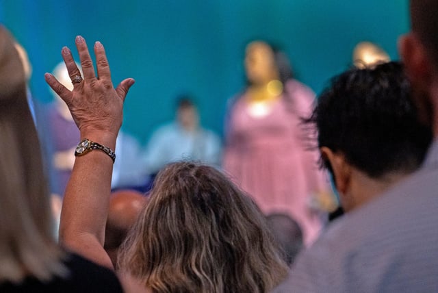 A woman raises her hand in praise during the Southern Baptist Convention, Tuesday, June 11, 2024 at the Indiana Convention Center. The Nashville-based SBC, which is the nation's largest Protestant denomination, is among the faith groups experiencing consistent decline, according to the Pew Research Center's latest Religious Landscape Study.