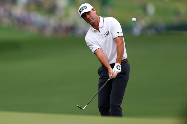 Austin Eckroat of the United States chips onto the first green during the first round of the 2024 Masters Tournament at Augusta National Golf Club on April 11, 2024 in Augusta, Georgia.