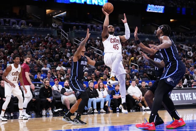 ORLANDO, FLORIDA - FEBRUARY 25: Donovan Mitchell #45 of the Cleveland Cavaliers goes up for a shot against Paolo Banchero #5 of the Orlando Magic during the third quarter at Kia Center on February 25, 2025 in Orlando, Florida. NOTE TO USER: User expressly acknowledges and agrees that, by downloading and or using this photograph, User is consenting to the terms and conditions of the Getty Images License Agreement. (Photo by Rich Storry/Getty Images)