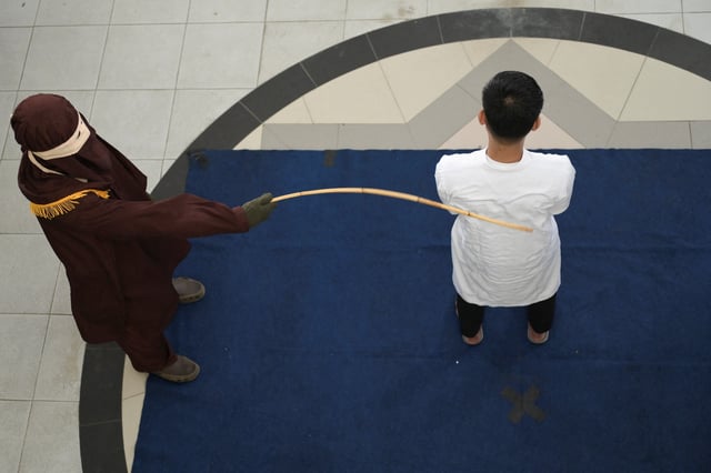 A man convicted of having same sex relationship is publicly caned by a Sharia Law official in Banda Aceh, Indonesia, February 27, 2025. REUTERS/Riska Munawarah
