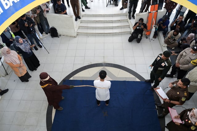 A man convicted of having same sex relationship is publicly caned by a Sharia Law official in Banda Aceh, Indonesia, February 27, 2025. REUTERS/Riska Munawarah
