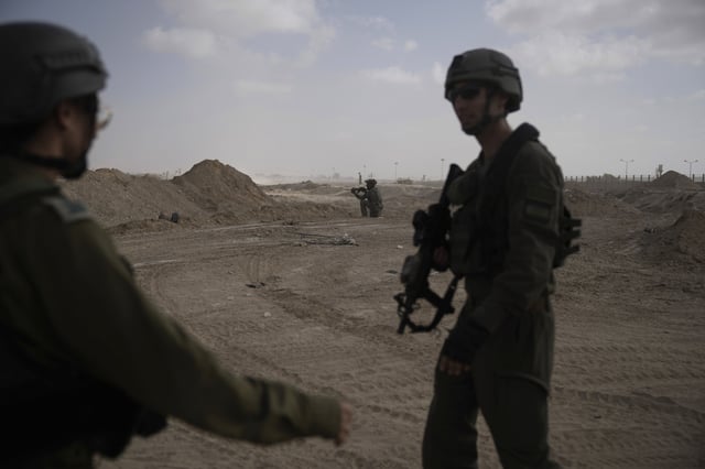 FILE - Israeli soldiers take up positions next to the Philadelphi Corridor along the border with Egypt, in the Gaza Strip, Sept. 13, 2024. (AP Photo/Leo Correa, File)