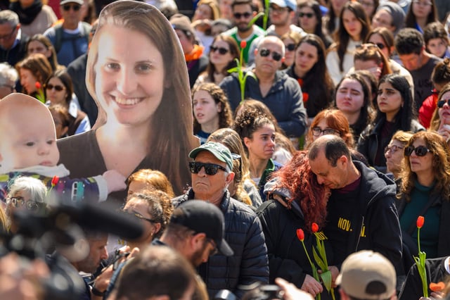 A crowd watches a live feed from a funeral for Shiri, Ariel and Kfir Bibas in Hostages Square in Tel Aviv on Feb. 26.