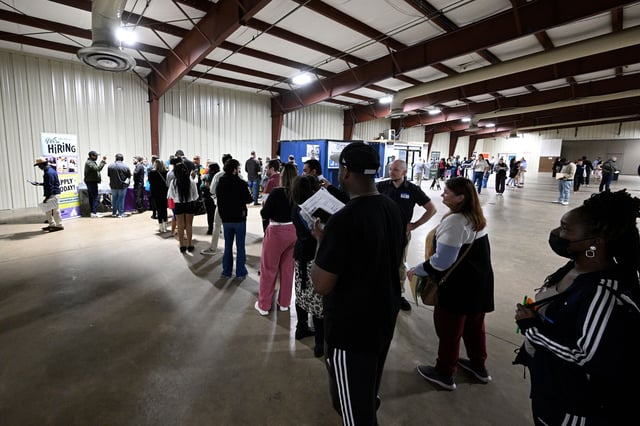 Job seekers stand in line while waiting to talk with Walt Disney World recruiters in Orlando on January 29.