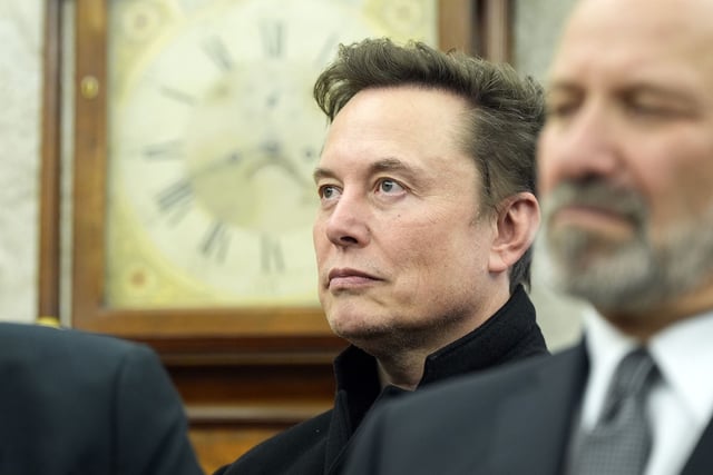 Elon Musk listens as President Donald Trump meets with India's Prime Minister Narendra Modi in the Oval Office of the White House, Thursday, Feb. 13, 2025, in Washington.