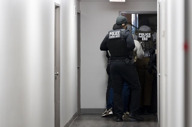 U.S. Immigration and Customs Enforcement officers enter a residence looking for a suspect, Monday, Jan. 27, 2025, in Takoma Park, Maryland.