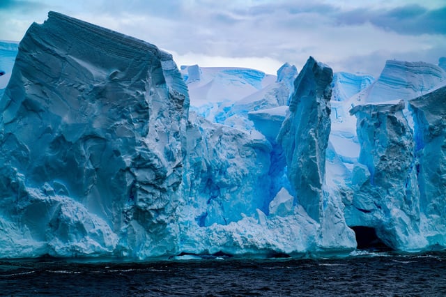 The surprisingly blue cast to this ice is caused by a lack of air trapped inside the glacier, which causes blue light to be trapped inside.