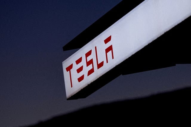 A view of Tesla logo at an electric vehicle charging station between Los Angeles and Las Vegas in Baker, California, U.S., November 19, 2024. REUTERS/Mike Blake//File Photo