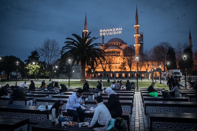 Families break their Ramadan fast in front of the Blue Mosque on April 13, 2021, in Istanbul, Turkey.