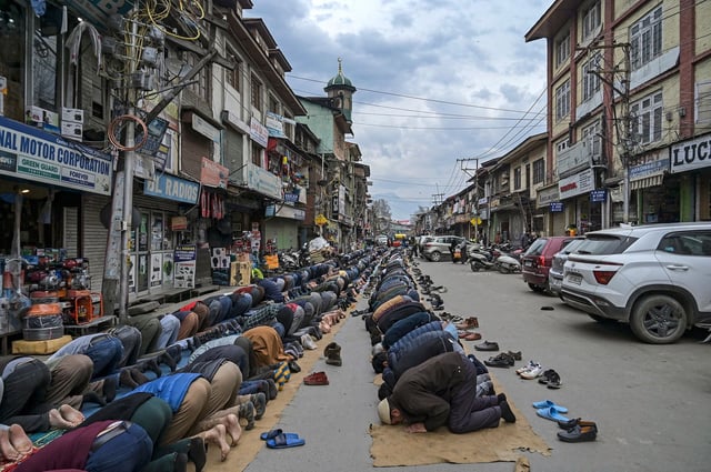 Muslim devotees offer prayers outside a mosque during the Islamic holy month of Ramadan along a street in Srinagar, in Indian-administered Jammu and Kashmir, on March 13, 2024.