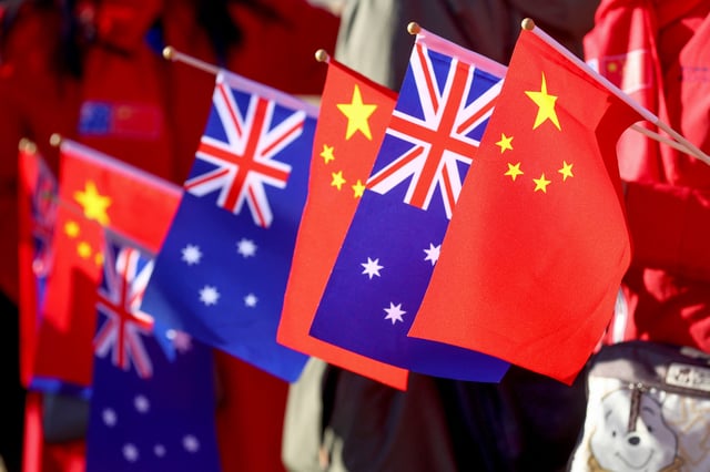 Supporters of Chinese Premier Li Qiang hold Australian and Chinese flags as wait for his arrival at Magill Estate winery in Adelaide, Australia, Sunday, June 16, 2024. Li is on the second leg of a weeklong tour New Zealand, Australia and Malaysia.     Kelly Barnes/Pool via REUTERS/File Photo