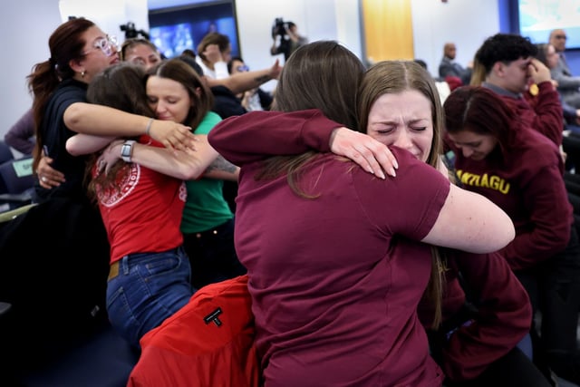 Brittany De Leon, center-right, and Olivia Goldstein, both 2nd and 3rd grade teachers at Acero’s Santiago Elementary, embrace after the Chicago Public Schools board voted to keep open a number of Acero schools while keeping open two others through the 2025-2026 school year. The vote took place at CPS Headquarters on Feb. 27, 2025. Santiago is one of the schools to be kept open. (Chris Sweda/Chicago Tribune)