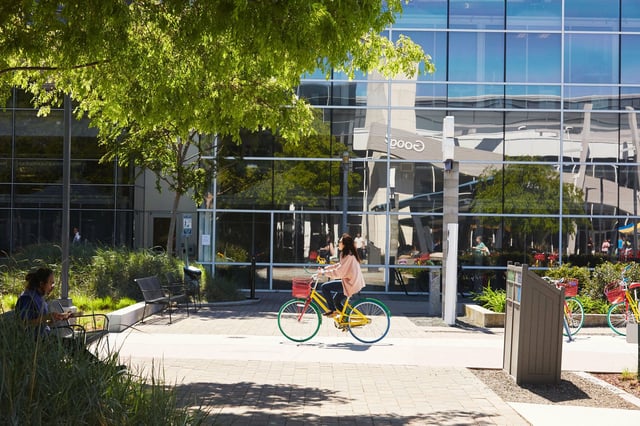 An employee rides a bicycle on the Google campus in Mountain View. Google announced hundreds of additional layoffs across several teams this week, including its Cloud, Advertising, and Trust &amp; Safety units — with employees tracking the cuts through a crowdsourced document.