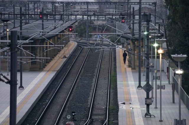 Security patrol at the Greek capital's shuttered main railway station in central Athens, Greece, to mark two years since a deadly rail disaster that has also triggered hundreds of other demonstrations and a general strike, on Friday, Feb. 28, 2025. (AP Photo/Thanassis Stavrakis)