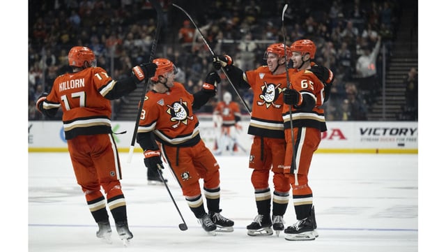 Ducks defenseman Jackson LaCombe (2) celebrates his goal with center Mason McTavish (23), left wing Alex Killorn (17) and defenseman Jacob Trouba (65) during the third period of their game against the Vancouver Canucks on Thursday night at the Honda Center. The Ducks scored five unanswered goals for a 5-2 win. (AP Photo/Kyusung Gong)