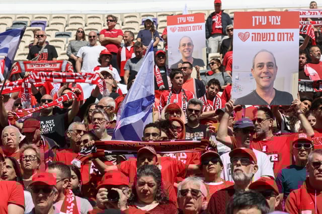 Hapoel Tel Aviv supporters gather in the club's Bloomfield Stadium to mourn fellow fan Tsachi Idan who was abducted to Gaza and died in captivity.
