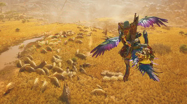Gliding over a heard of monsters on the plains in Monster Hunter Wilds.