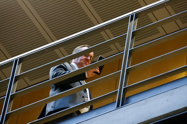 German Defense Minister Boris Pistorius holds his phone following a meeting between Christian Democratic Union (CDU) leader and Chancellor-in-waiting Friedrich Merz and Lars Klingbeil, co-leader of the Social Democratic Party (SPD), in Berlin, Germany, February 28, 2025. REUTERS/Axel Schmidt