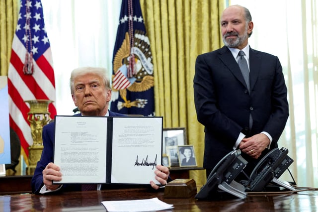 U.S. President Donald Trump holds an executive order about tariffs increase, flanked by U.S. Commerce Secretary Howard Lutnick, in the Oval Office of the White House in Washington, D.C., U.S., February 13, 2025. REUTERS/File Photo