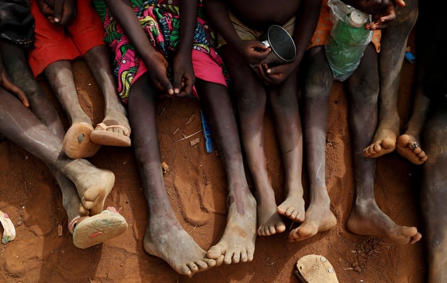Orphans and children separated from their parents in Kadugli gather to eat boiled leaves at an IDP Camp within the Sudan People's Liberation Movement-North (SPLM-N) controlled area in Boram County, Nuba Mountains, South Kordofan, Sudan June 22, 2024. REUTERS/Thomas Mukoya/File Photo