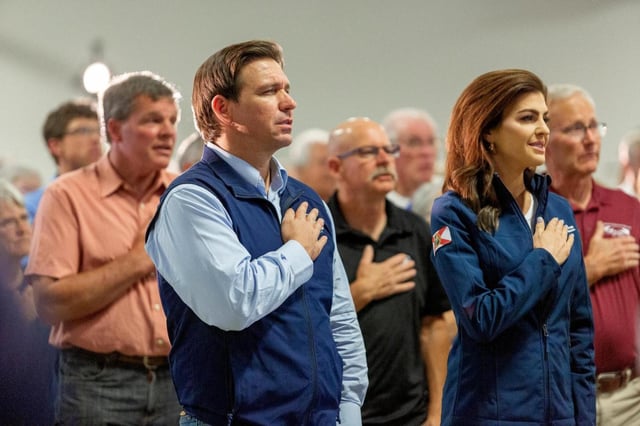 Florida Gov. Ron DeSantis and his wife Casey, during the Pledge of Allegiance at a presidential primary campaign appearance in Cedar Rapids, Iowa, May 31, 2023. DeSantis, 44, was born after the Vietnam War, came of age when computers were common in American homes and he still has young children of his own. If elected, he would be younger than every president since John F. Kennedy. (Rachel Mummey/New York Times)