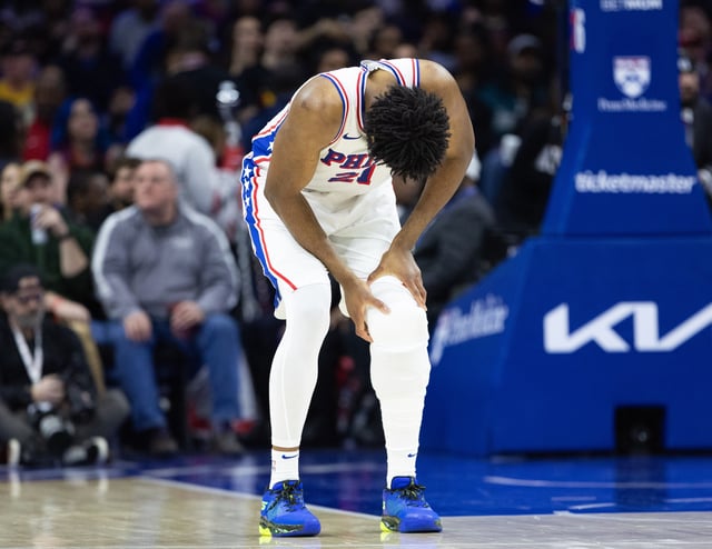 Feb 22, 2025; Philadelphia, Pennsylvania, USA; Philadelphia 76ers center Joel Embiid (21) holds his leg after a play against the Brooklyn Nets during the second quarter at Wells Fargo Center. Mandatory Credit: Bill Streicher-Imagn Images/File Photo
