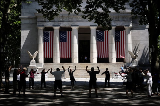 Senior citizens exercise together in front of the General Grant National Memorial in upper Manhattan, in New York City, U.S. June 29, 2022. REUTERS/Mike Segar/File Photo