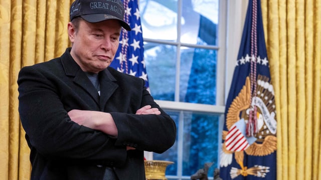 Elon Musk listens as US President Donald Trump speaks in the Oval Office of the White House in Washington, DC, on February 11, 2025. 