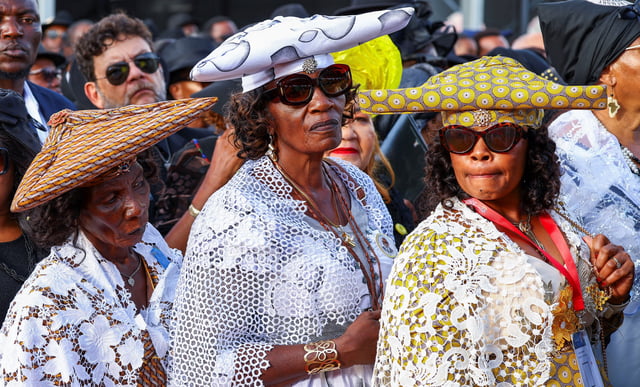 Women in traditional Herero dresses wait to view the body during a memorial service of Sam Nujoma, who became Namibia's first democratically elected president, at the Independence stadium, before his burial tomorrow at Namibia's National Heroes Acre, in the capital Windhoek, Namibia, February 28, 2025. REUTERS/Siphiwe Sibeko