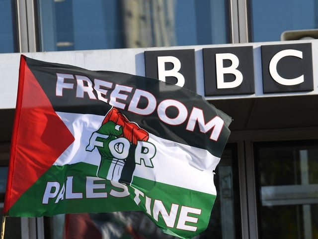 A Palestinian flag is waved outside the BBC Scotland building as people take part in a demonstration to show solidarity with the Palestinian People, in Glasgow on October 14, 2023, in support of "their right to resistance". British Prime Minister Rishi Sunak called on Israel Friday to take "every possible precaution to protect civilians" in its response to last weekend's deadly attack by Hamas. (Photo by ANDY BUCHANAN / AFP) (Photo by ANDY BUCHANAN/AFP via Getty Images)
