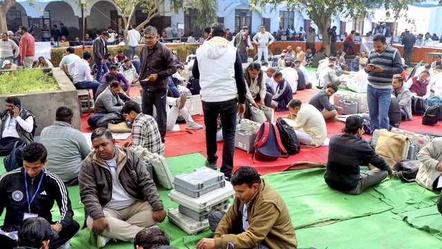 Polling officials at an EVM distribution centre on the eve of the Haryana municipal elections, in Rohtak, Saturday