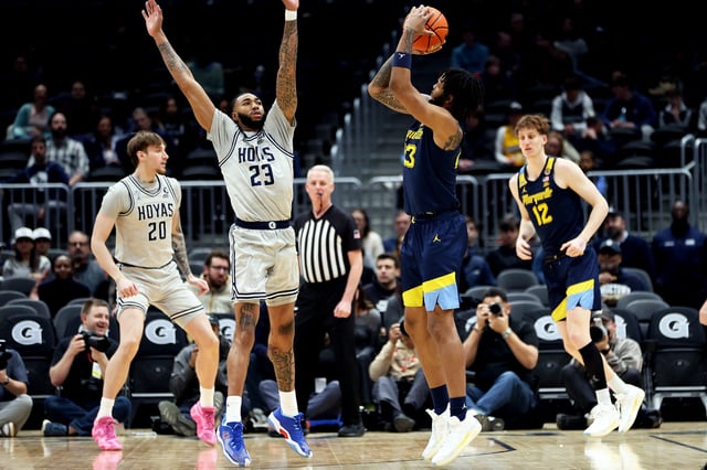 Mar 1, 2025; Washington, District of Columbia, USA; Marquette Golden Eagles forward David Joplin (23) takes a shot over Georgetown Hoyas forward Jordan Burks (23) during the first half at Capital One Arena. Mandatory Credit: Daniel Kucin Jr.-Imagn Images