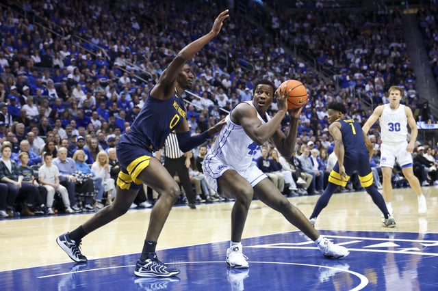 Mar 1, 2025; Provo, Utah, USA; Brigham Young Cougars center Fousseyni Traore (45) goes to the basket against West Virginia Mountaineers center Eduardo Andre (0) during the first half at Marriott Center. Mandatory Credit: Rob Gray-Imagn Images