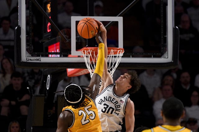 Mar 1, 2025; Nashville, Tennessee, USA;  Vanderbilt Commodores guard Chris Manon (30) blocks the shot of  Missouri Tigers guard Mark Mitchell (25) during the first half at Memorial Gymnasium. Mandatory Credit: Steve Roberts-Imagn Images
