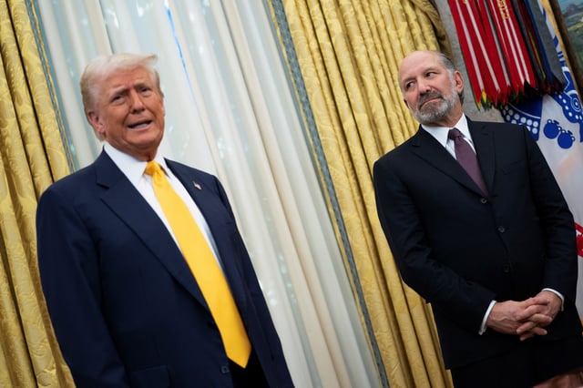 U.S. President Donald Trump speaks alongside Howard Lutnick in the Oval Office of the White House on the day Lutnick is sworn in as U.S. Commerce Secretary by U.S. Vice President JD Vance, in Washington, D.C., U.S., February 21, 2025. REUTERS/Nathan Howard/File Photo