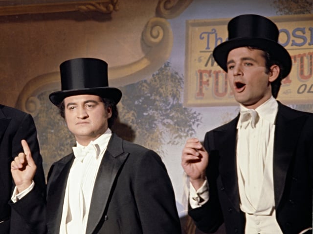 SATURDAY NIGHT LIVE -- Episode 19 -- Pictured: (l-r) Elliott Gould, John Belushi, Bill Murray during the monologue on April 16, 1977 -- (Photo by: NBC/NBCU Photo Bank)