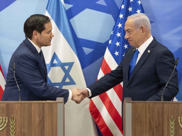U.S. Secretary of State Marco Rubio, left, and Israeli Prime Minister Benjamin Netanyahu shake hands during a news conference at the Prime Minister's office in Jerusalem, Israel, Sunday, Feb. 16, 2025. (AP Photo/Ohad Zwigenberg,Pool)