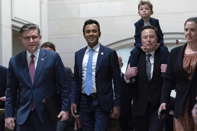 Speaker of the House Mike Johnson, R-La., from left, walks with Vivek Ramaswamy and Elon Musk, who is carrying his son X Æ A-Xii, as they walk to a meeting to discuss President-elect Donald Trump&#39;s planned Department of Government Efficiency, on Capitol Hill in Washington, Dec. 5, 2024.