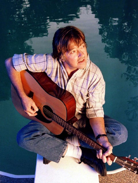 Joey Molland, guitarist of the rock group "Badfinger" plays his instrument in the backyard of his Shoreview home, Sept. 9, 1997.