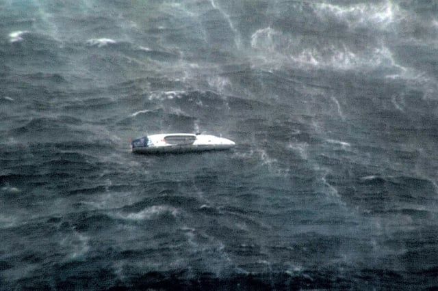 A handout photo released and taken on March 2, 2025 by the Australian Department of Defence shows an image taken in the Coral Sea from a Royal Australian Air Force P-8A Poseidon aircraft as it flies above the vessel of Aurimas Mockus from Lithuania, after he activated his emergency beacon during his attempt to row across the Pacific Ocean