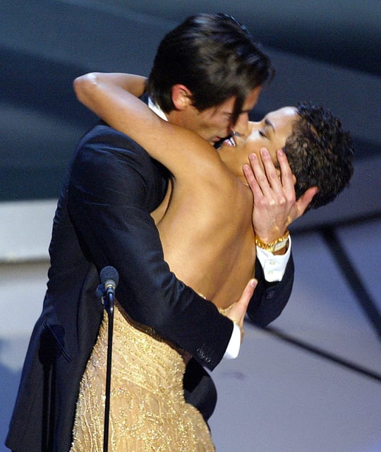 Actor Adrien Brody kisses presenter Halle Berry as he accepts his Oscar for his role in "The Pianist" during the 75th Academy Awards at the Kodak Theatre in Hollywood, California on March 23, 2003.